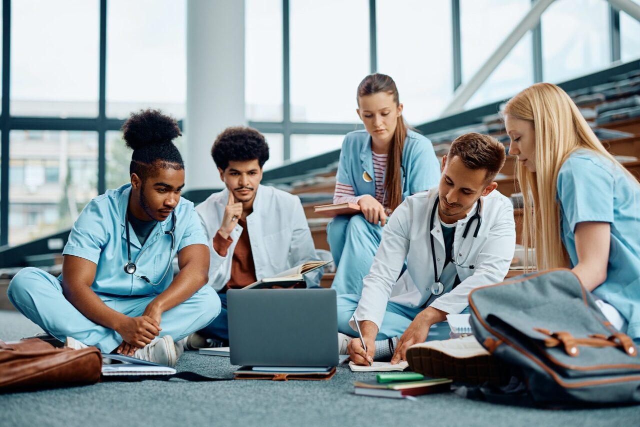 students of medicine using laptop while learning together in lecture hall at the university